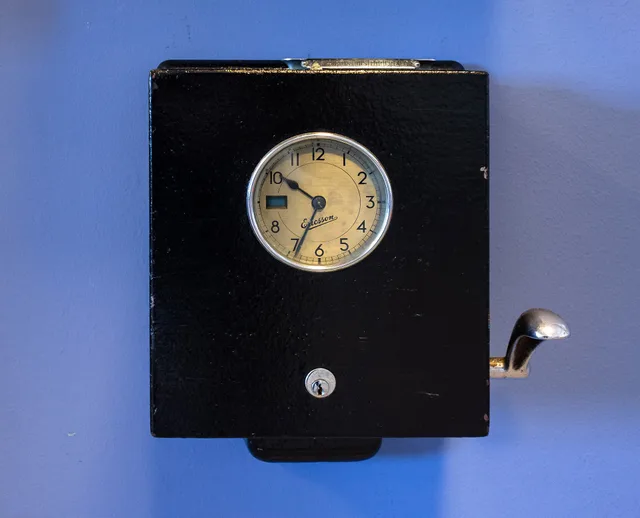 An old LM Ericsson tidkontroll punch clock in the Lysekil Work Center, Lysekil, Sweden. How overtime and break rules affect residential maid teams